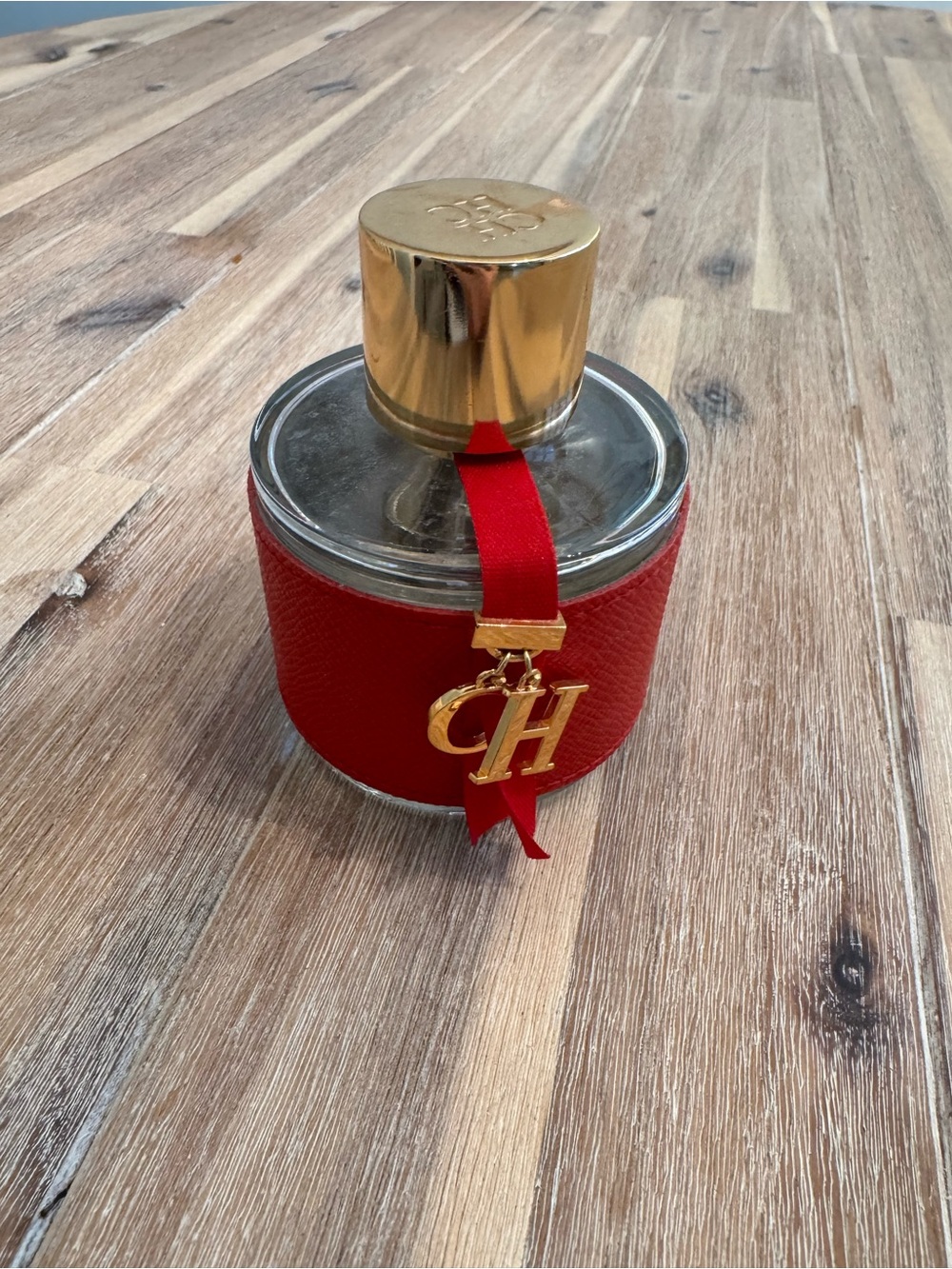 Carolina Herrera Red and Gold Round Fragrance Bottle with CH Charm ***empty ***